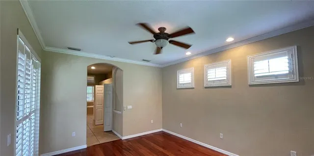 a view of a livingroom with a window and wooden floor