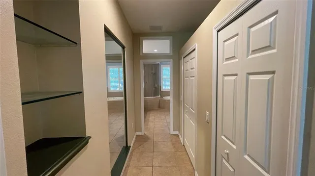 a view of walk in closet with empty racks