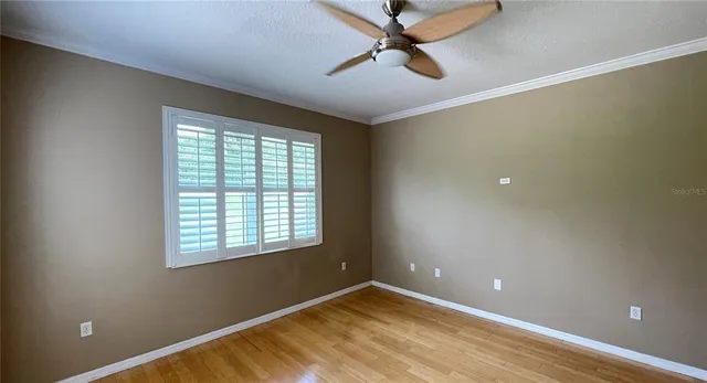 a view of a livingroom with a ceiling fan and window