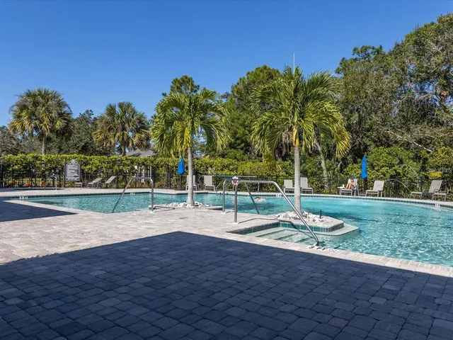 a view of a park with fire pit and couches