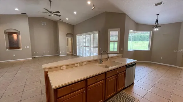 a bathroom with a granite countertop sink a large mirror and a shower