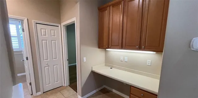 a view of a hallway with wooden shelves