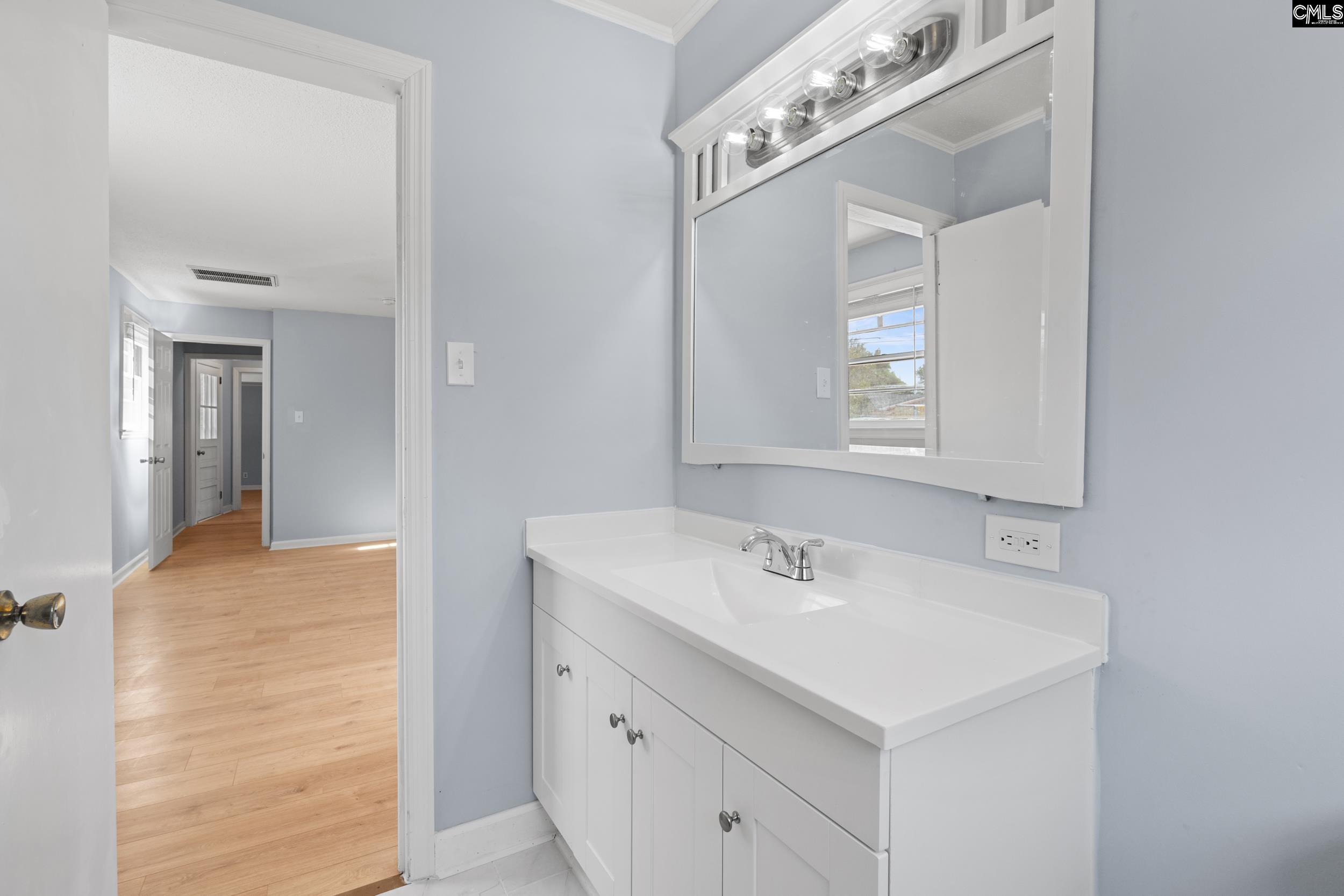 409 Wilkes Road Columbia, SC 29203 - Photo 16 of 34 a bathroom with a sink vanity and mirror