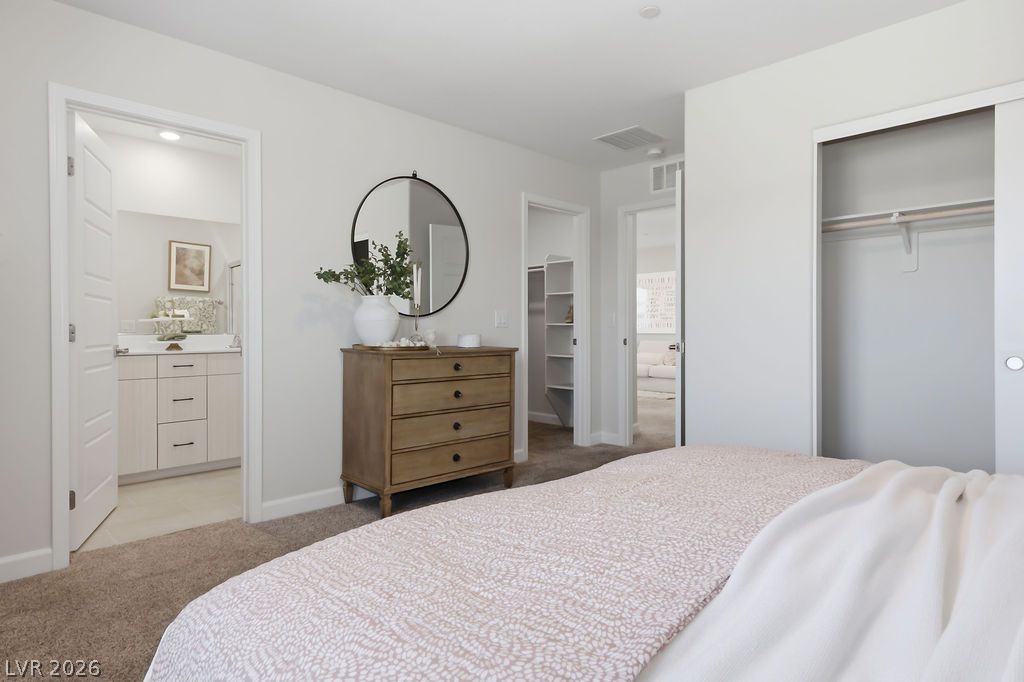 913 Cadence View Way Henderson, NV 89011 - Photo 29 of 46 A quiet bedroom offers convenient access to an en-suite bathroom and closet space.