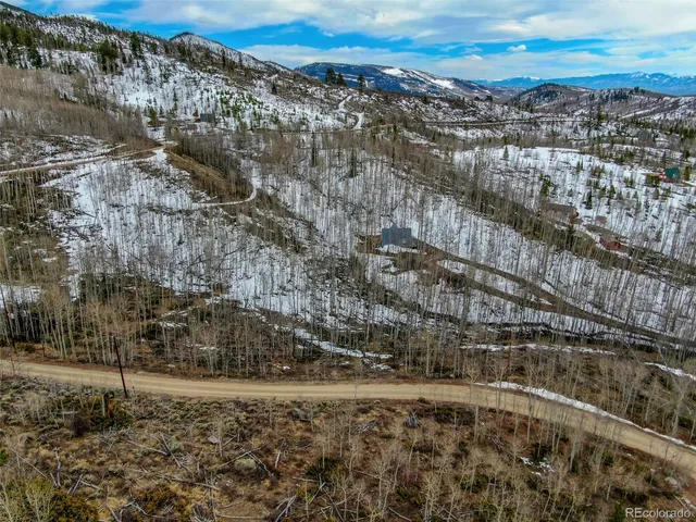 a view of a building with mountains in the background