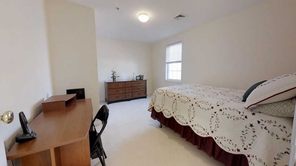 985 Trapelo Road, Unit 20 Waltham, MA 02452 - Photo 13 of 16 a bedroom with bed and a window