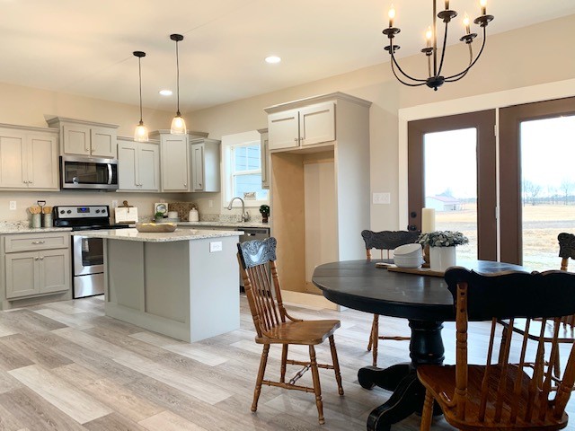 6076 Brown Road Springfield, TN 37172 - Photo 5 of 17 a kitchen with stainless steel appliances granite countertop a stove a refrigerator a kitchen island a dining table and chairs