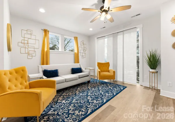 a living room with furniture rug and window