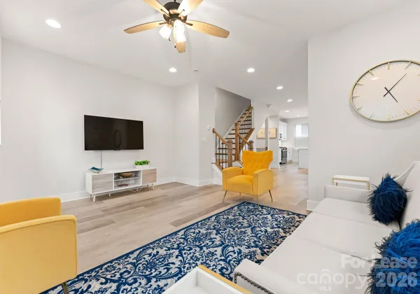 a bedroom with furniture and a flat screen tv