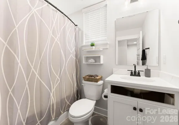 a white toilet sitting next to a bathroom sink