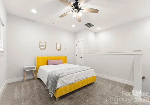 a bedroom with a bed and ceiling fan