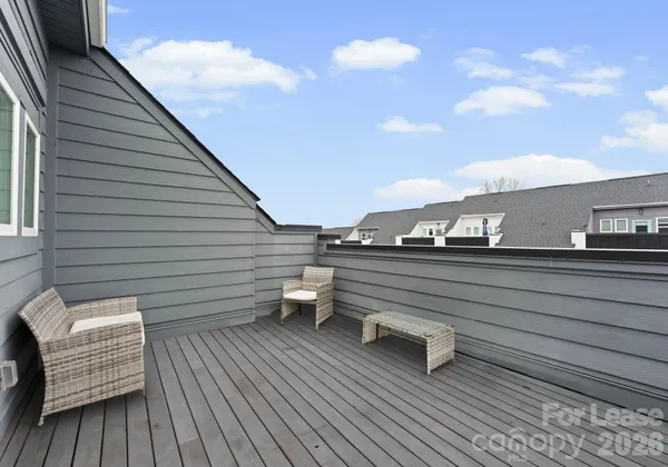 a roof deck view with a couch