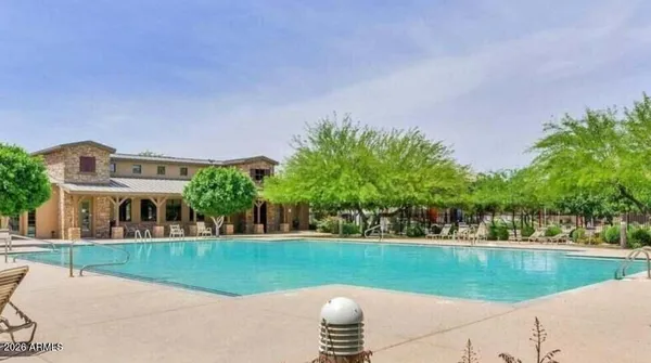 a view of a house with a yard and a fountain
