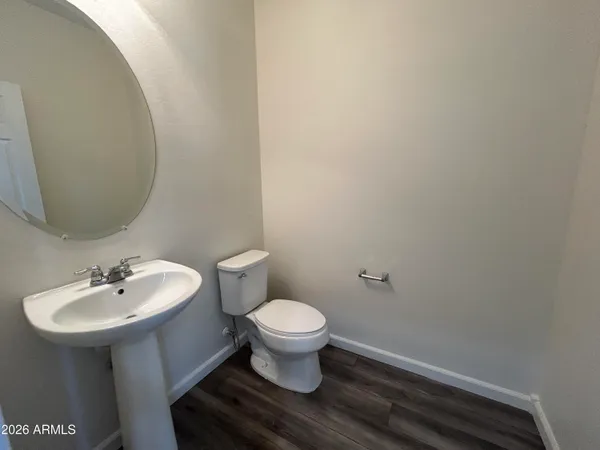 a bathroom with a sink toilet and a mirror