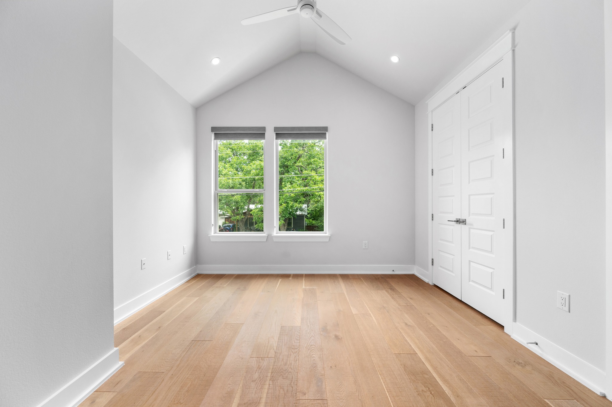 1409 Alegria Road, Unit A Austin, TX 78757 - Photo 18 of 24 Natural light floods this room, highlighting the clean lines of the hardwood floors and vaulted ceiling.