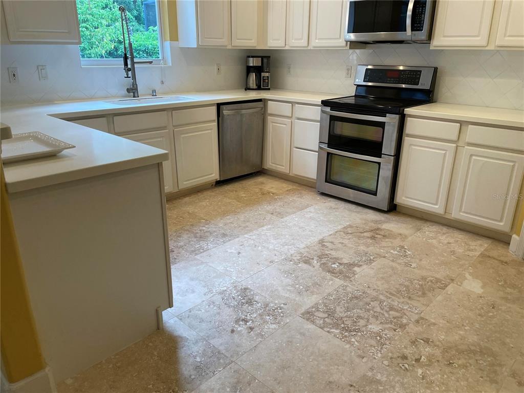 759 Fordingbridge Way Osprey, FL 34229 - Photo 35 of 51 a kitchen with a sink stove and cabinets
