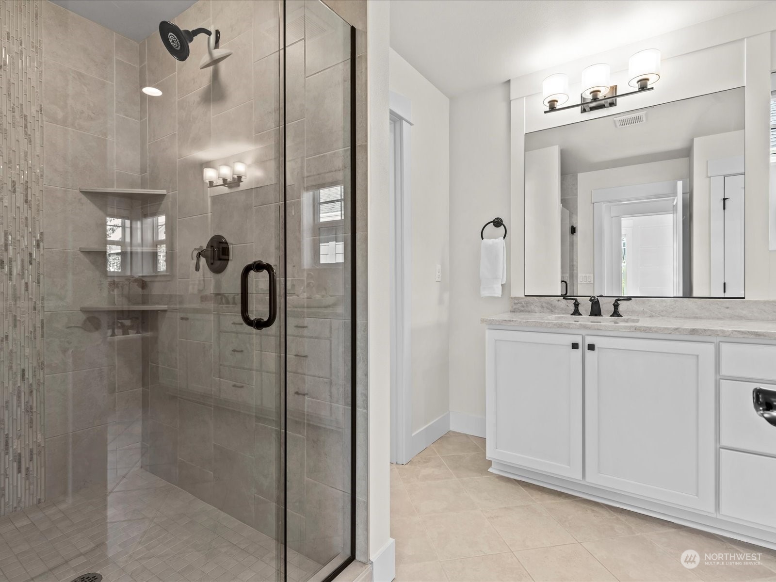 4431 187th Street Southeast Bothell, WA 98012 - Photo 28 of 39 a bathroom with a shower sink and mirror