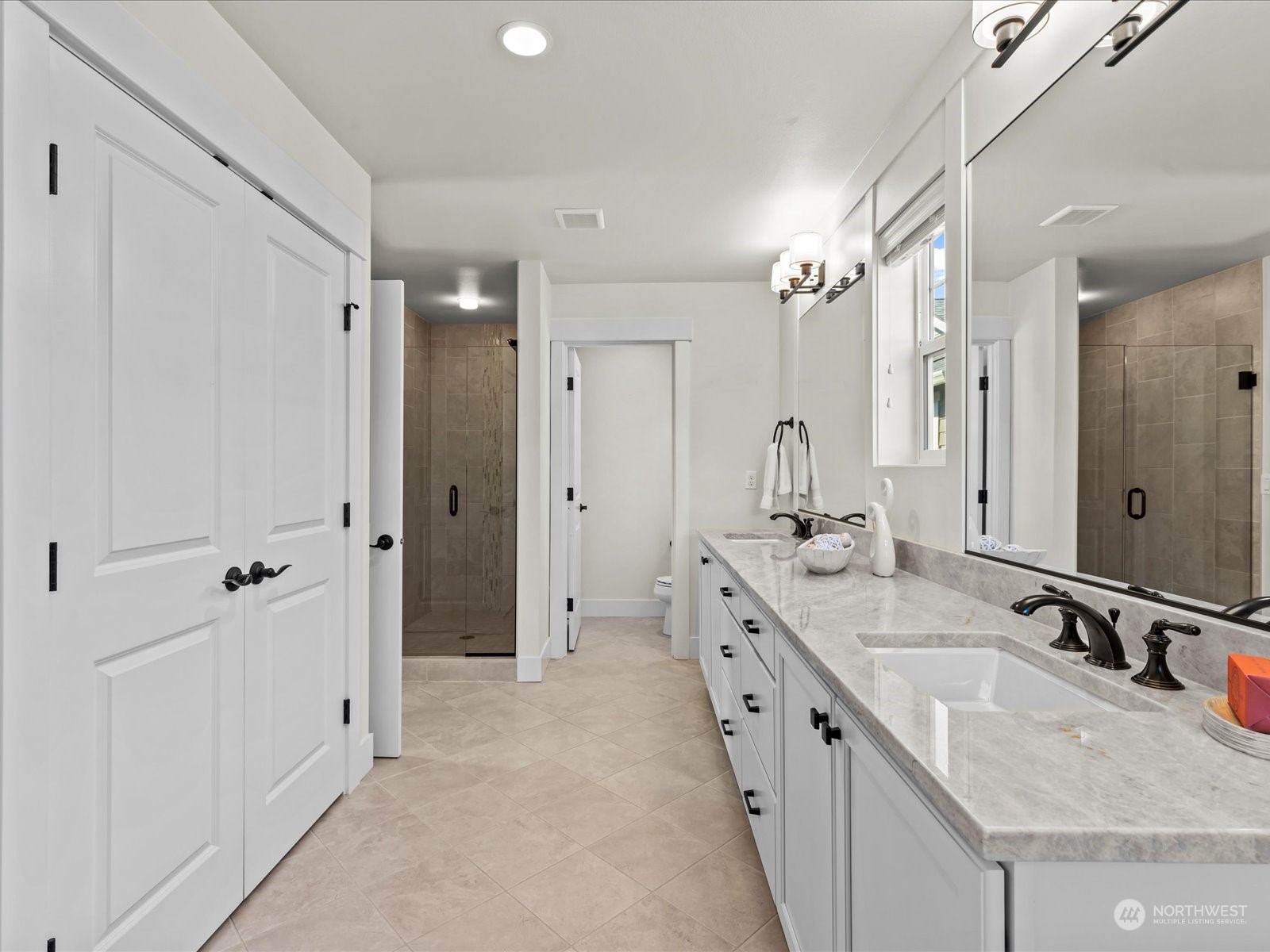 4431 187th Street Southeast Bothell, WA 98012 - Photo 29 of 39 a bathroom with a granite countertop double vanity sink a mirror and a shower