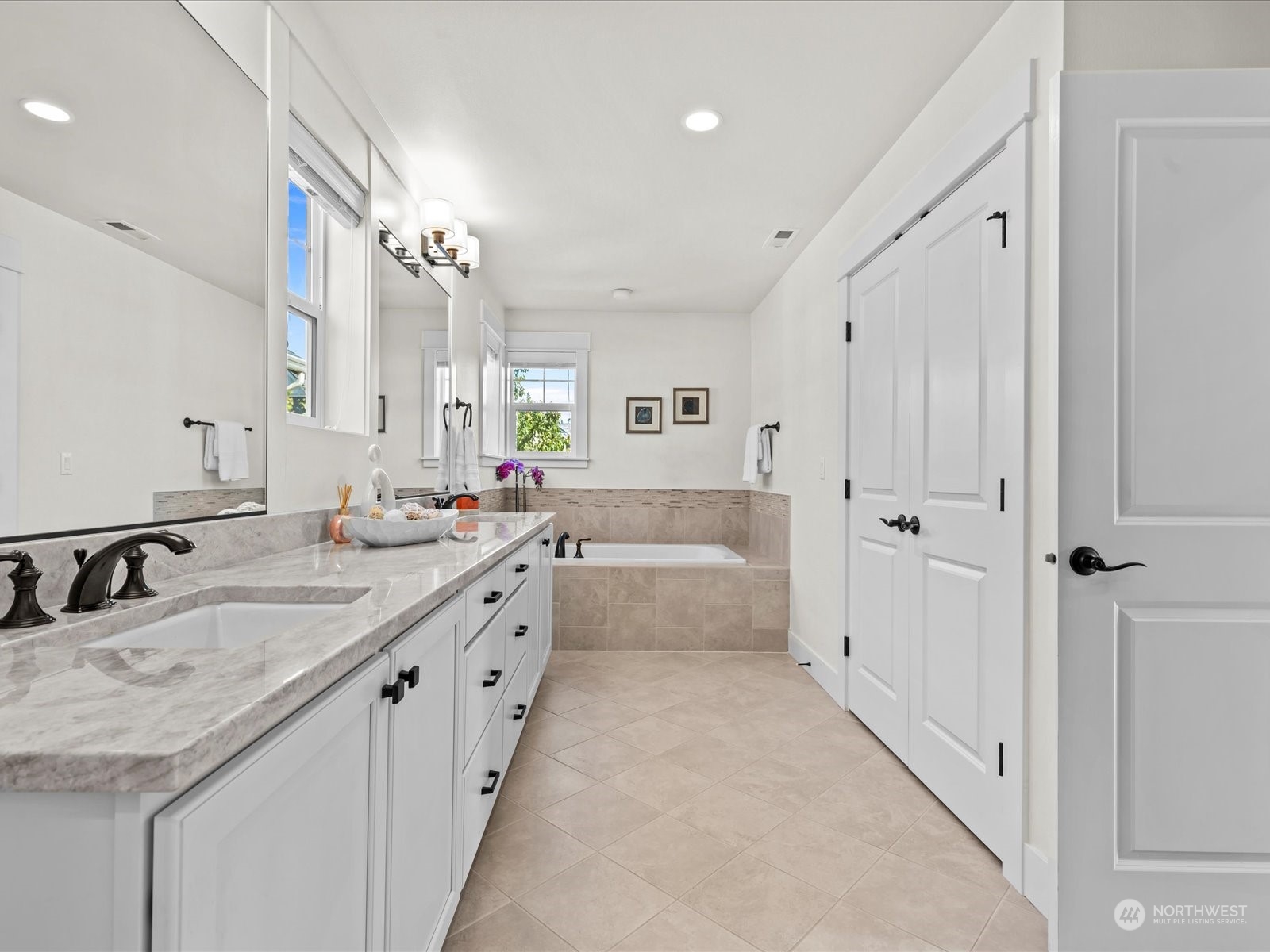 4431 187th Street Southeast Bothell, WA 98012 - Photo 30 of 39 a large white bathroom with a granite countertop double vanity sink a mirror and a bathtub