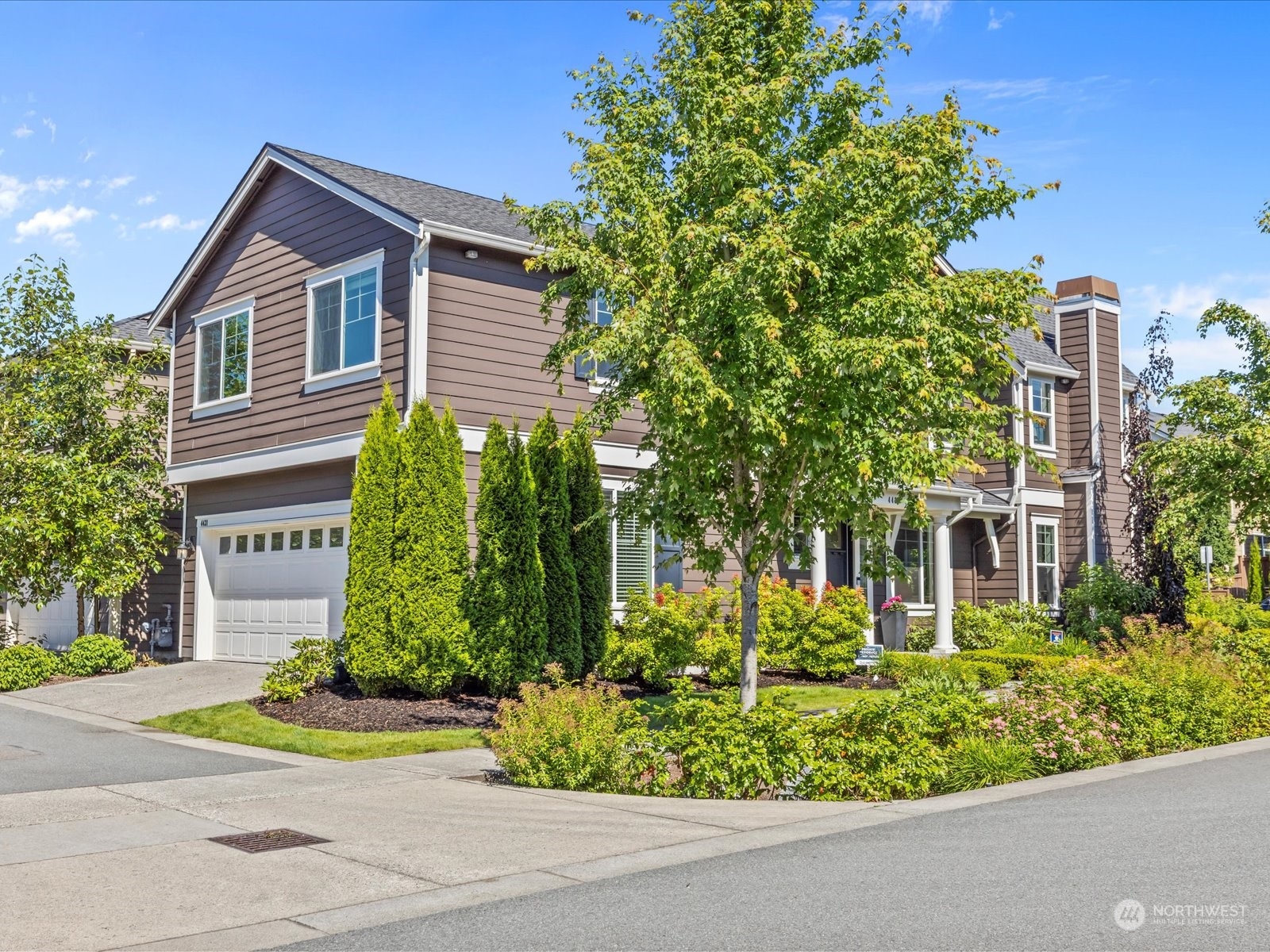 4431 187th Street Southeast Bothell, WA 98012 - Photo 3 of 39 a front view of a house with garden