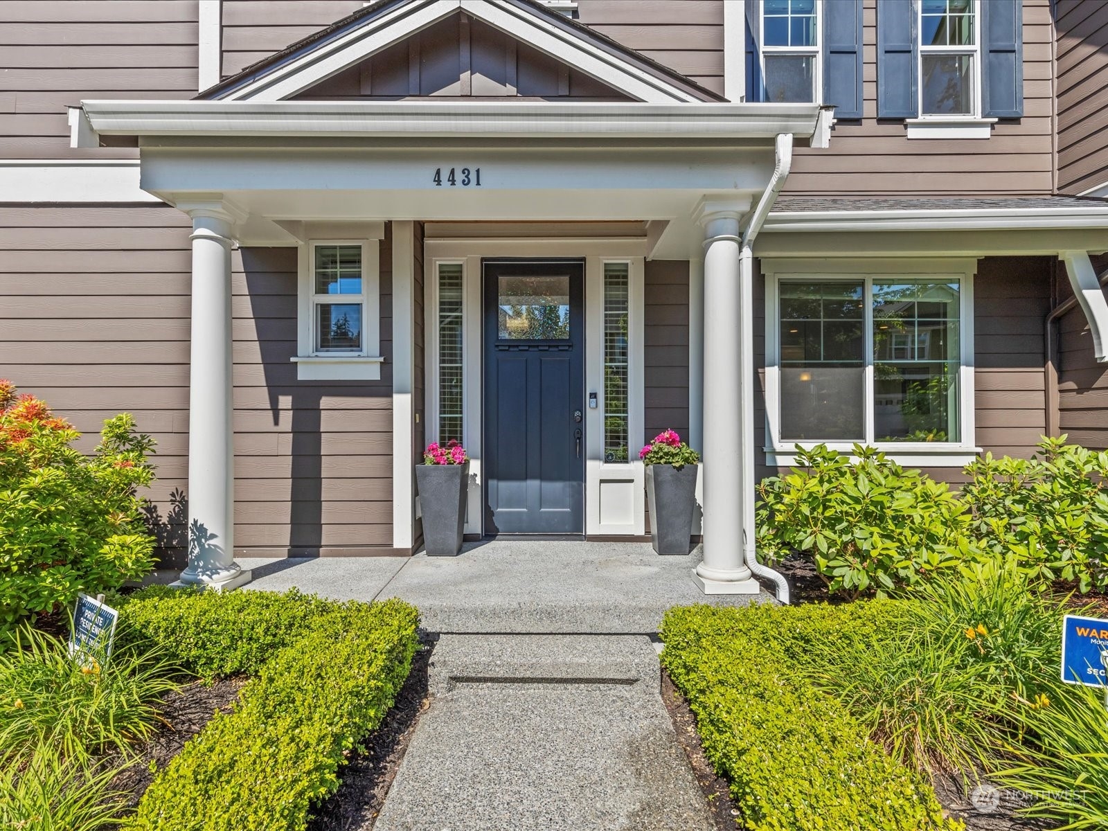 4431 187th Street Southeast Bothell, WA 98012 - Photo 4 of 39 front view of a house with a large window and potted plants