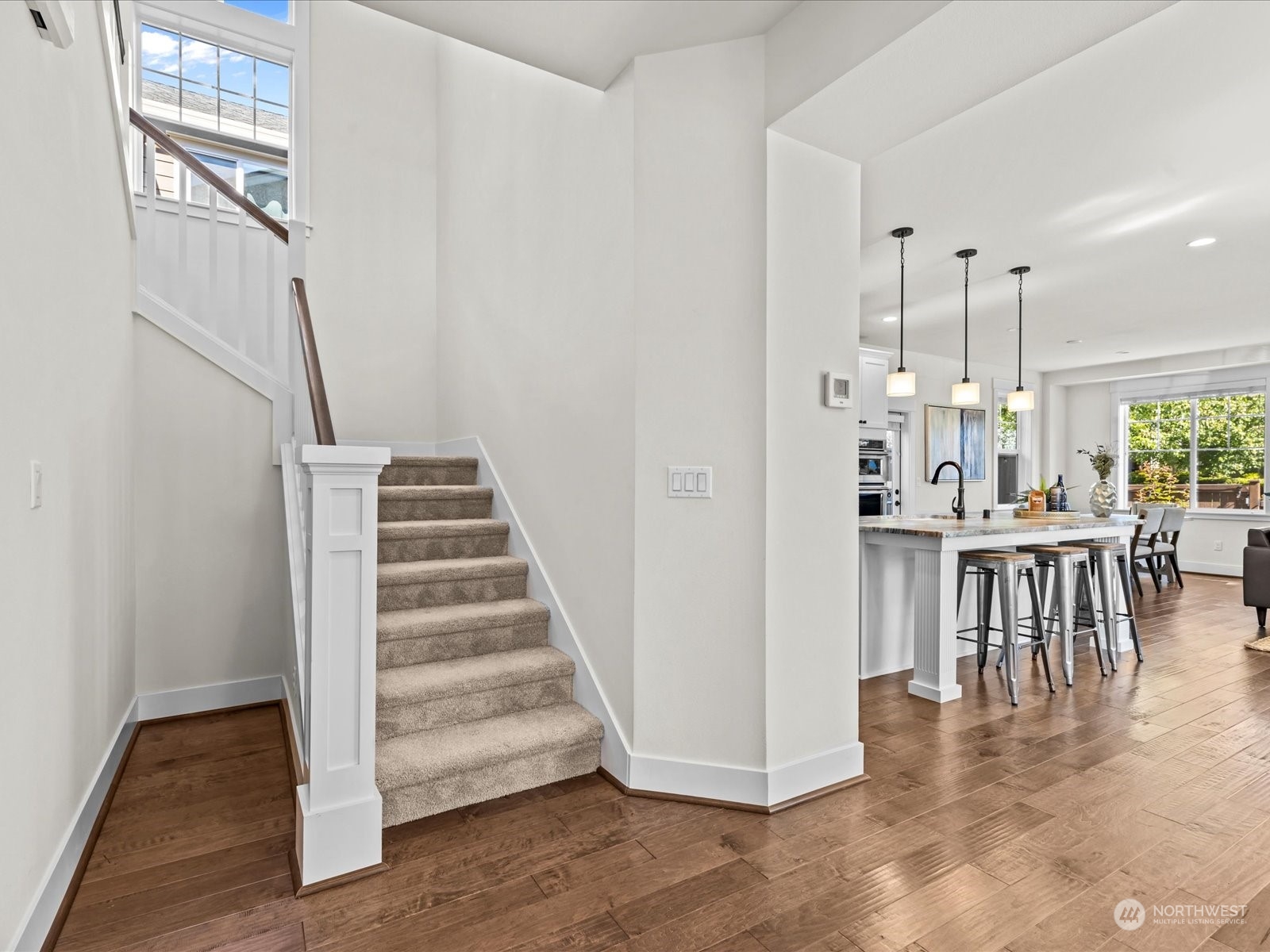 4431 187th Street Southeast Bothell, WA 98012 - Photo 6 of 39 a view of dining room with wooden floor and stairs