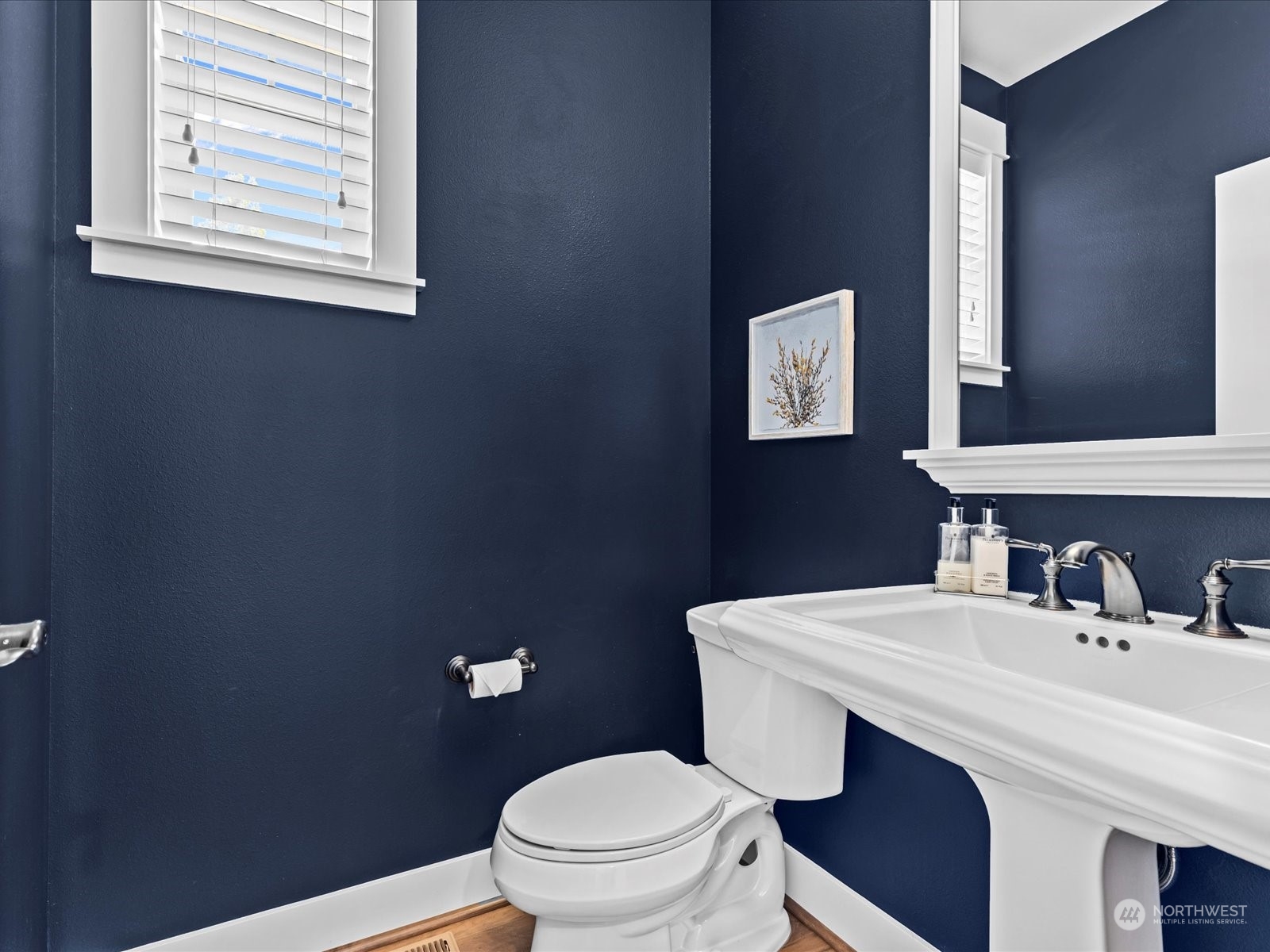 4431 187th Street Southeast Bothell, WA 98012 - Photo 7 of 39 a bathroom with a sink a toilet and mirror