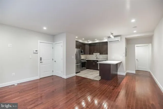 a view of kitchen with sink microwave and refrigerator