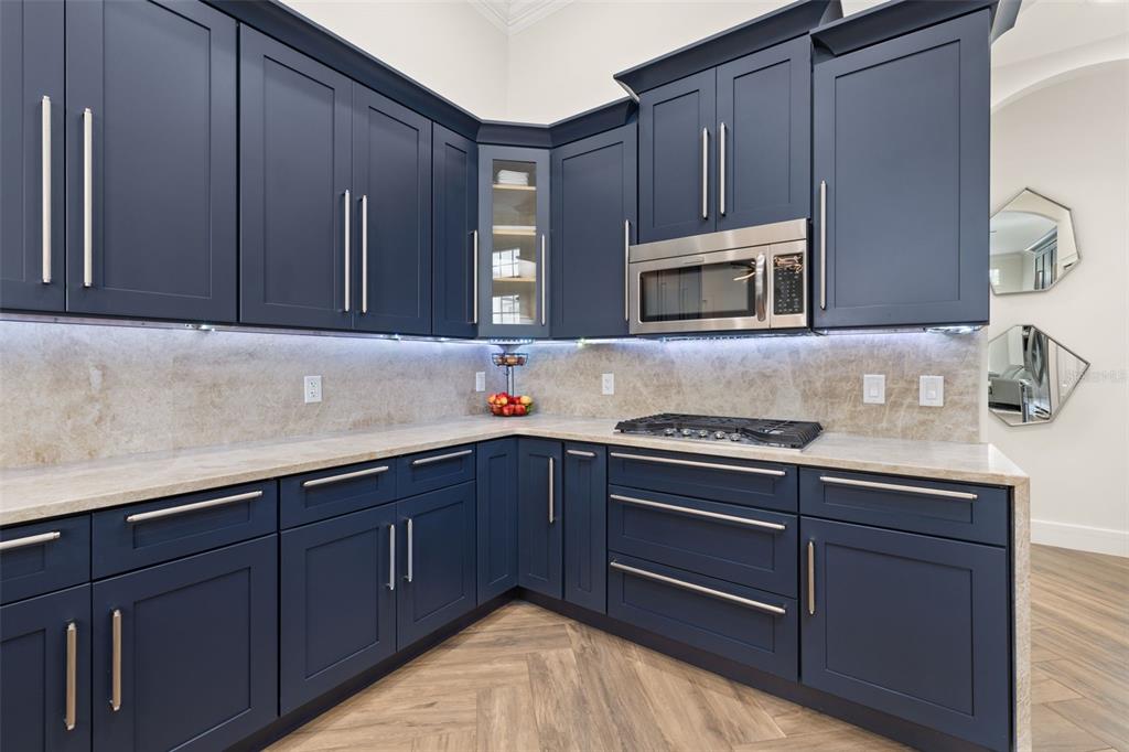 8351 Bowden Way Windermere, FL 34786 - Photo 12 of 71 a kitchen with wooden cabinets and a stove top oven