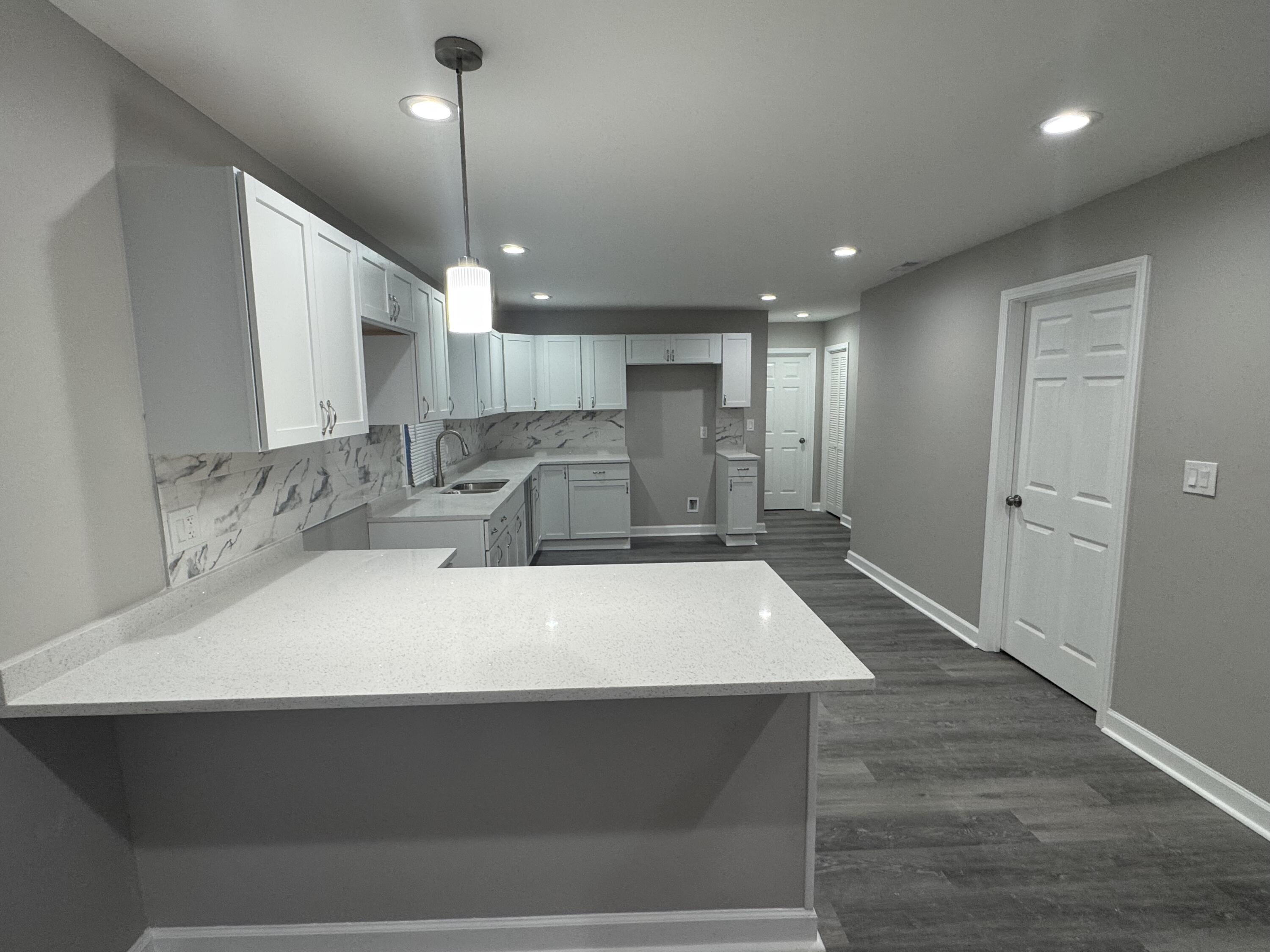 3428 Delaware Street Gary, IN 46409 - Photo 4 of 13 a large kitchen with kitchen island a sink stainless steel appliances and cabinets