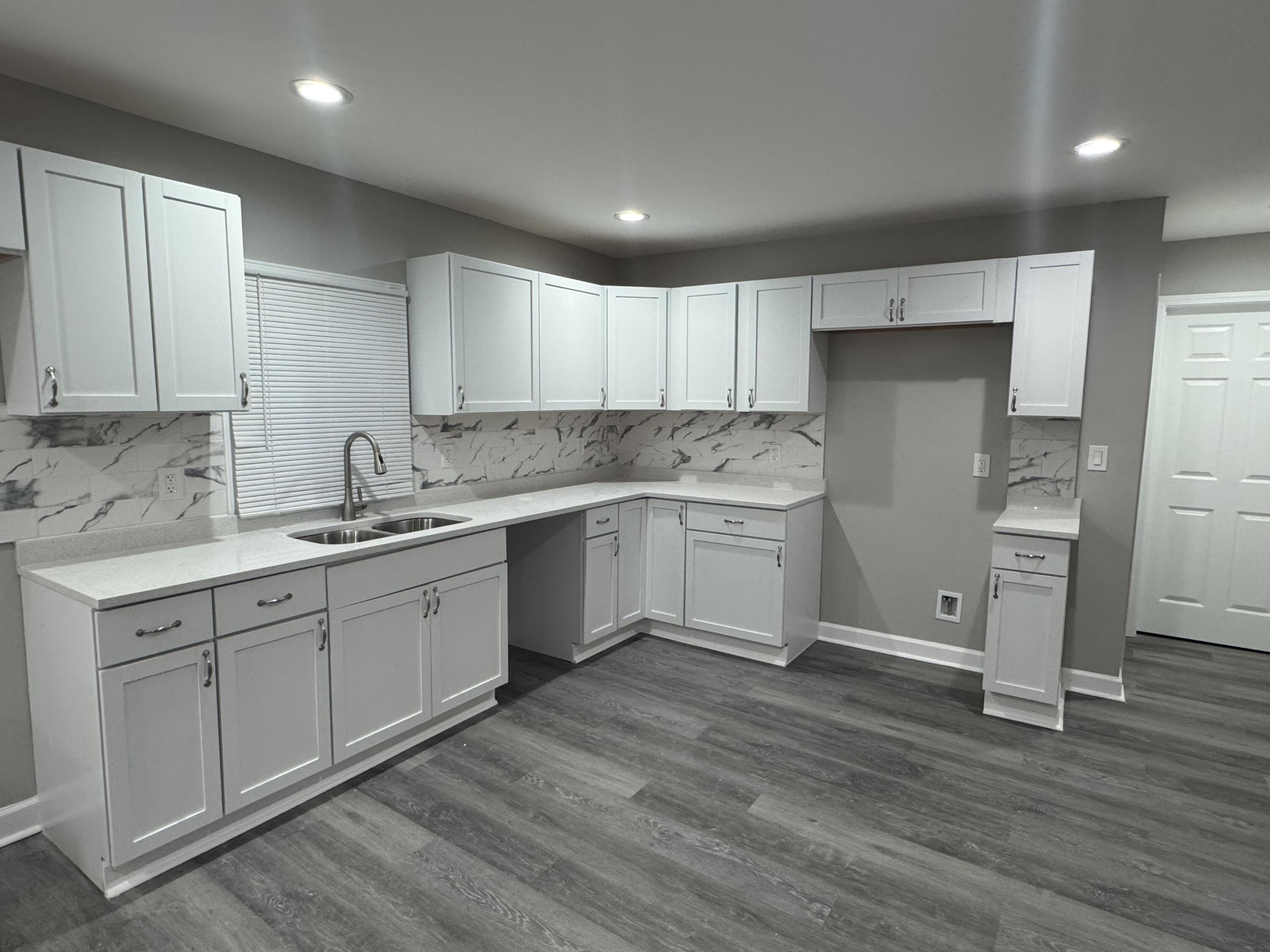 3428 Delaware Street Gary, IN 46409 - Photo 5 of 13 a kitchen with a sink cabinets stainless steel appliances and a window