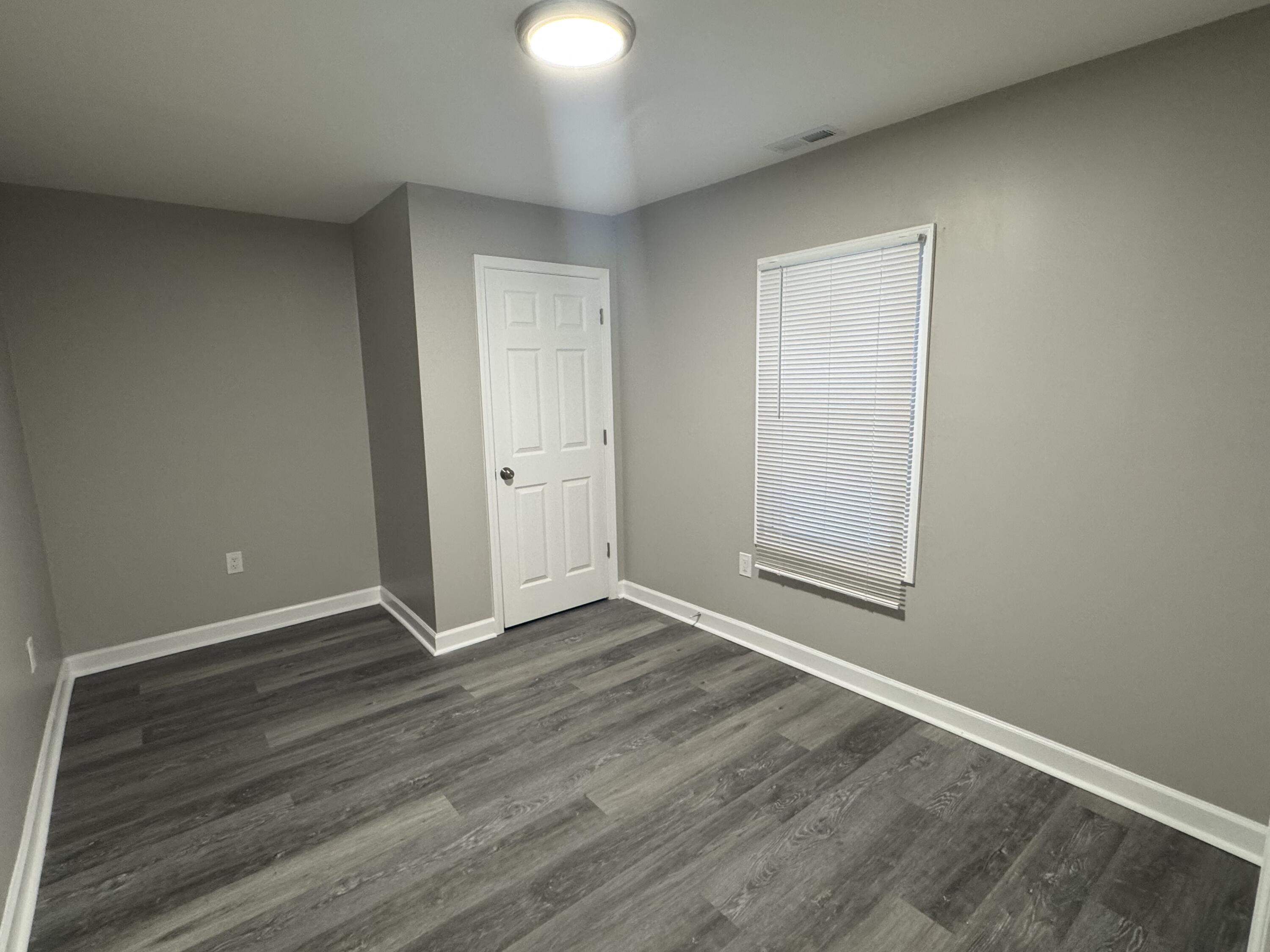 3428 Delaware Street Gary, IN 46409 - Photo 7 of 13 an empty room with wooden floor and windows