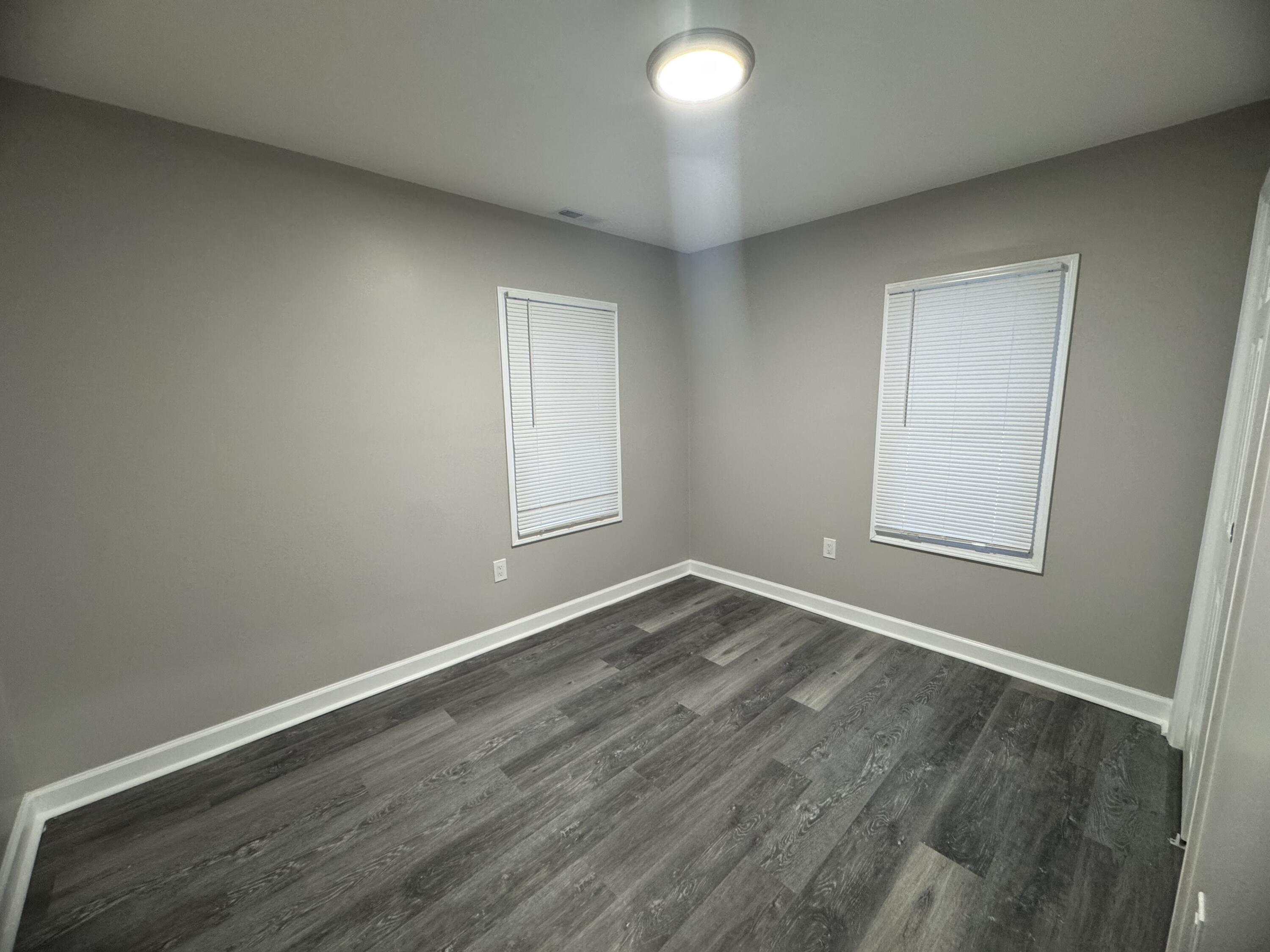 3428 Delaware Street Gary, IN 46409 - Photo 8 of 13 an empty room with wooden floor and windows