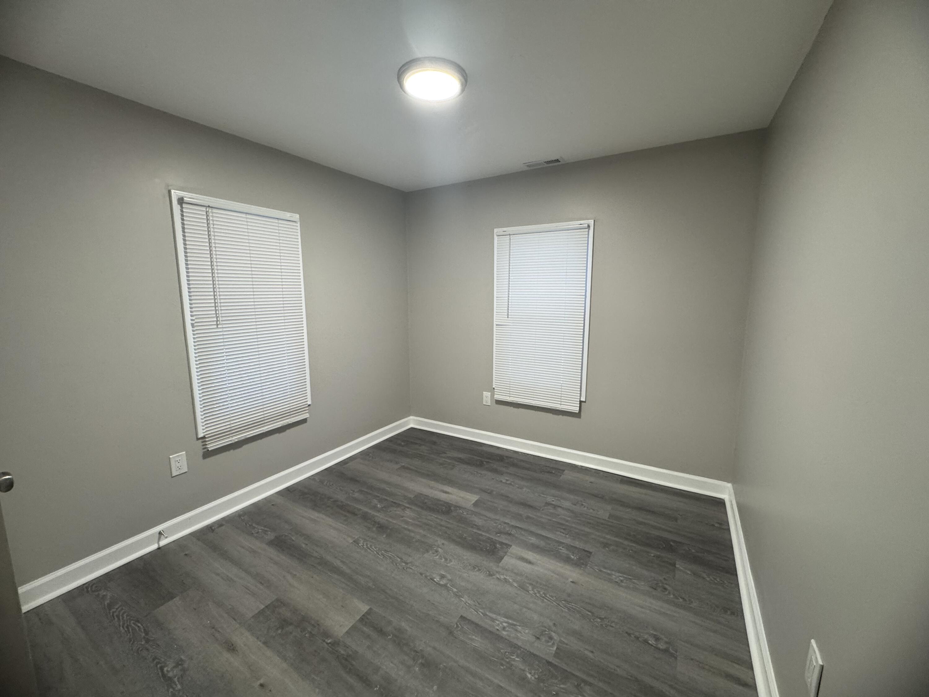 3428 Delaware Street Gary, IN 46409 - Photo 10 of 13 an empty room with wooden floor and windows