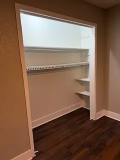 a view of a room with wooden shelves