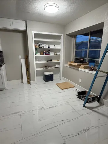 a view of room with wooden floor and ceiling fan