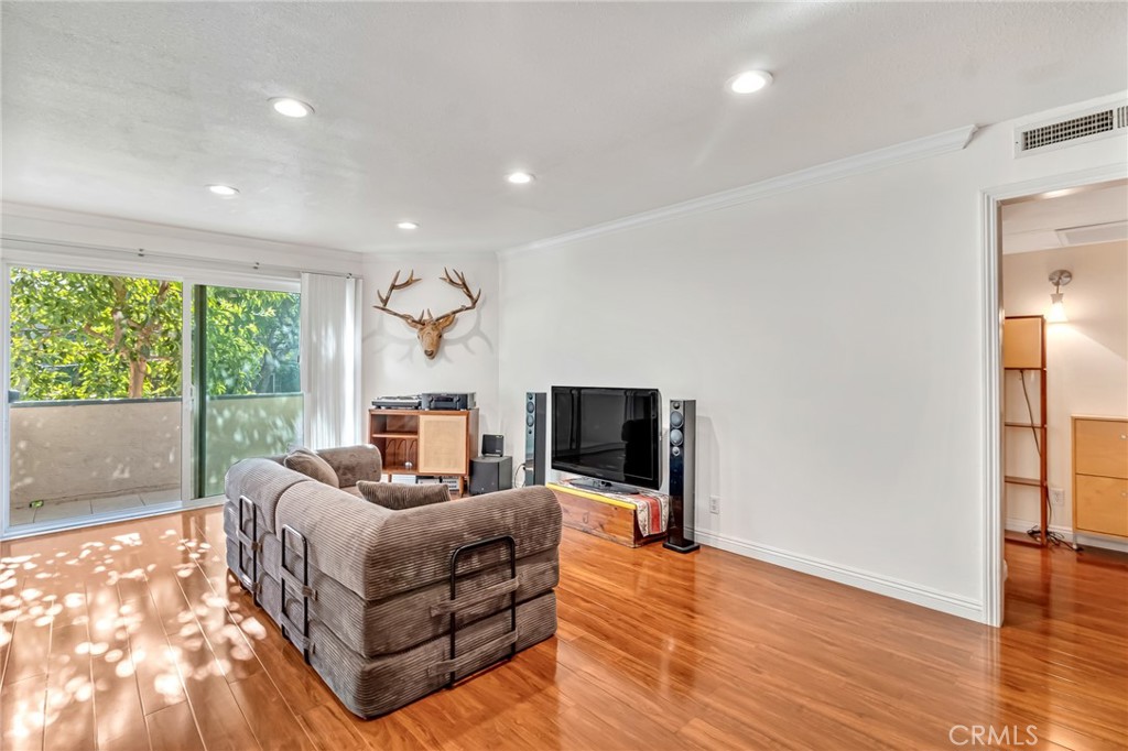 601 East Orange Grove Avenue, Unit 106 Burbank, CA 91501 - Photo 19 of 27 a bedroom with furniture and a flat screen tv