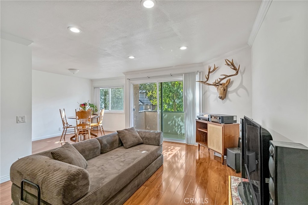 601 East Orange Grove Avenue, Unit 106 Burbank, CA 91501 - Photo 20 of 27 a living room with furniture a large window and gym equipment