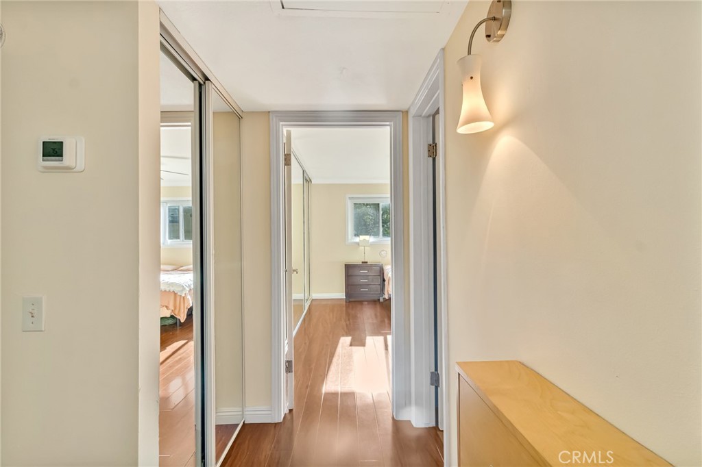601 East Orange Grove Avenue, Unit 106 Burbank, CA 91501 - Photo 24 of 27 a view of a hallway with wooden floor and a living room