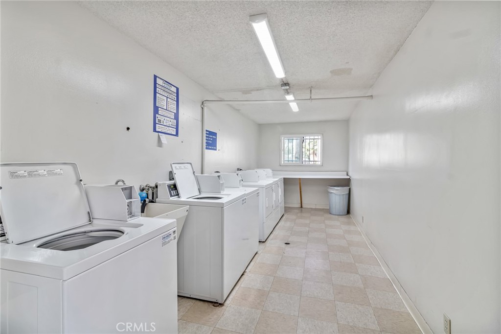 601 East Orange Grove Avenue, Unit 106 Burbank, CA 91501 - Photo 6 of 27 a view of a kitchen with refrigerator and white cabinets