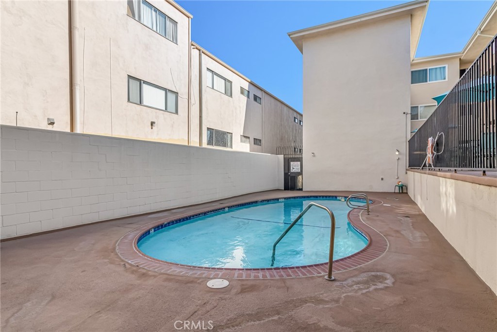 601 East Orange Grove Avenue, Unit 106 Burbank, CA 91501 - Photo 9 of 27 a view of a swimming pool with a house