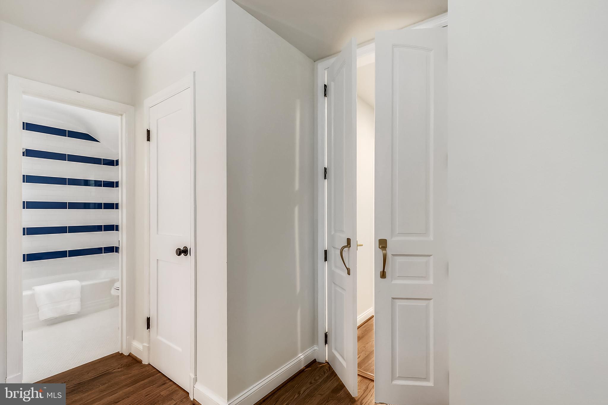 303 Penwood Road Silver Spring, MD 20901 - Photo 26 of 44 Upstairs Hall Bath and Primary Bedroom Entrance