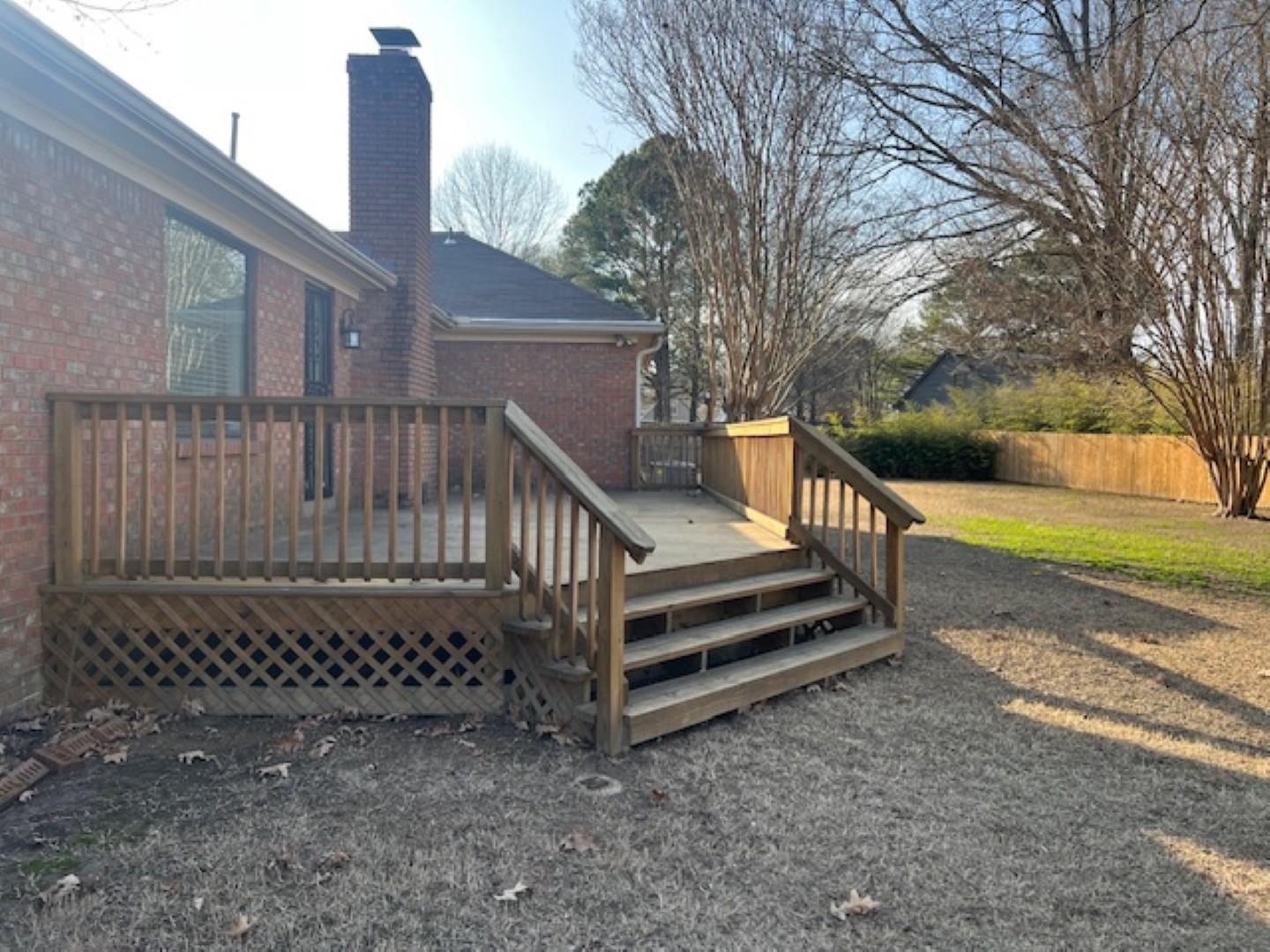 290 Rose Trellis Road Collierville, TN 38017 - Photo 15 of 17 a view of a yard with wooden fence and a bench