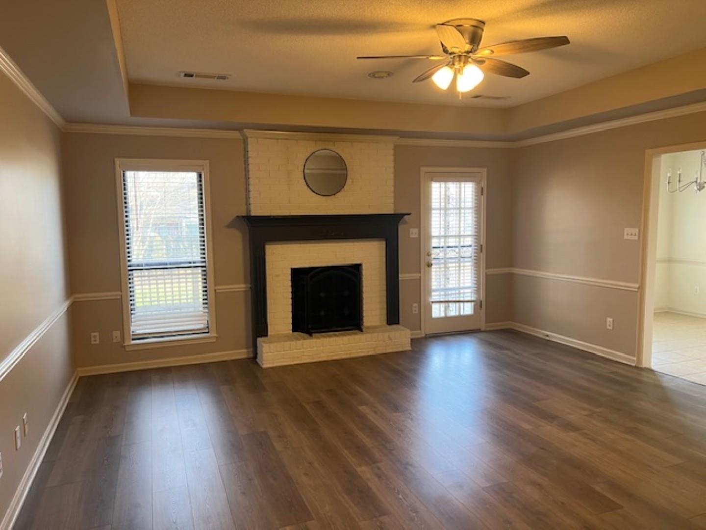 290 Rose Trellis Road Collierville, TN 38017 - Photo 4 of 17 a view of an empty room with wooden floor fireplace and a window