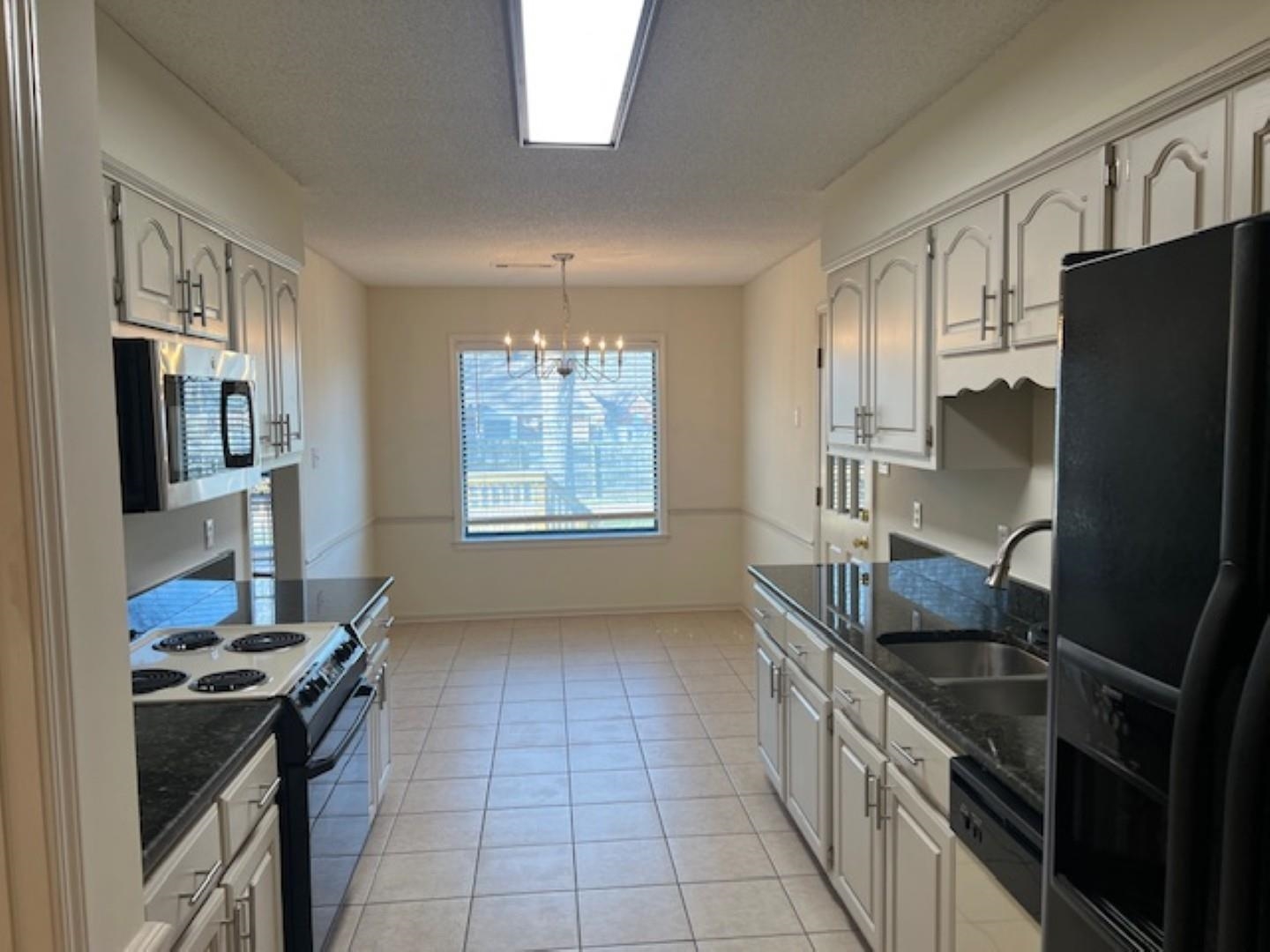 290 Rose Trellis Road Collierville, TN 38017 - Photo 5 of 17 a kitchen with stainless steel appliances granite countertop a sink stove and refrigerator