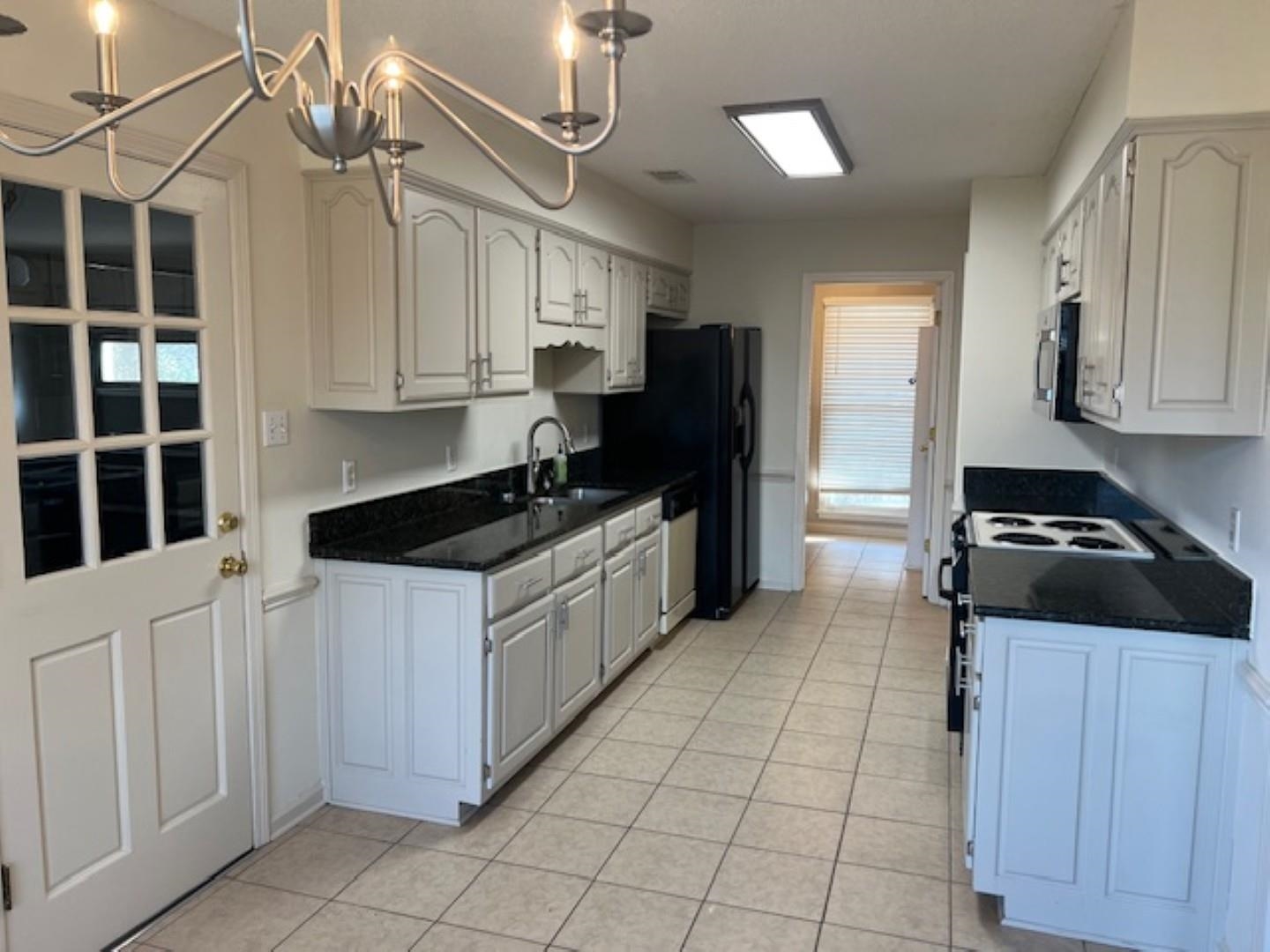 290 Rose Trellis Road Collierville, TN 38017 - Photo 6 of 17 a kitchen with a sink a stove and cabinets