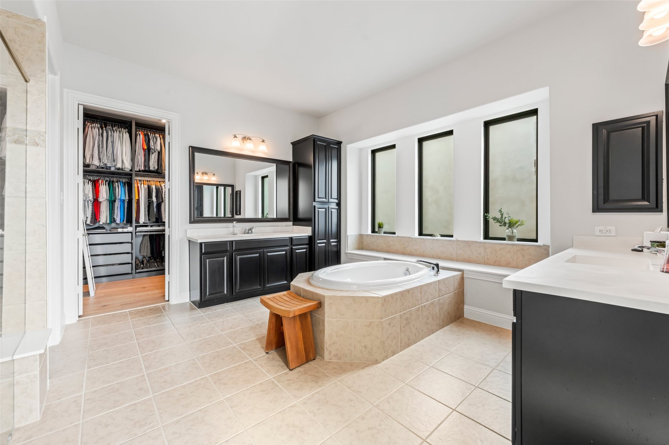 1053 Bat Hawk Court Conroe, TX 77385 - Photo 31 of 50 a large bathroom with a double vanity sink a mirror and a bathtub