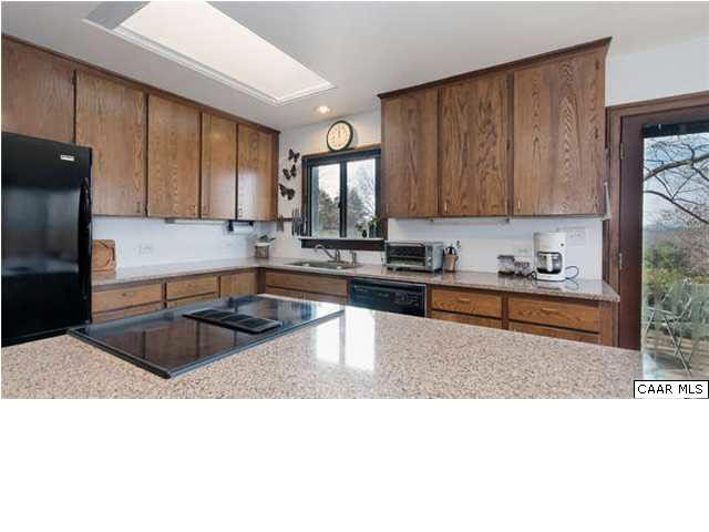 1747 Lambs Road Charlottesville, VA 22901 - Photo 12 of 24 a kitchen with a sink a counter top space cabinets and stainless steel appliances