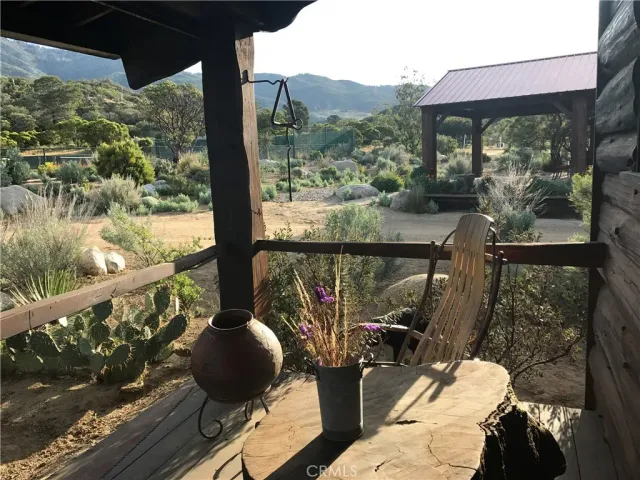 a view of a balcony with couches and wooden floor