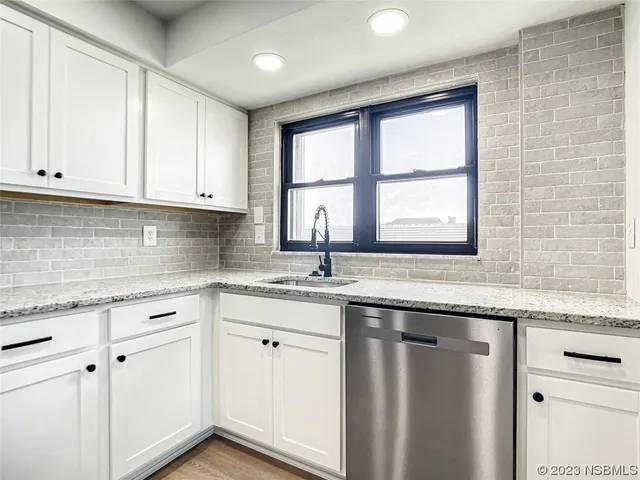 a kitchen with granite countertop a sink and a window